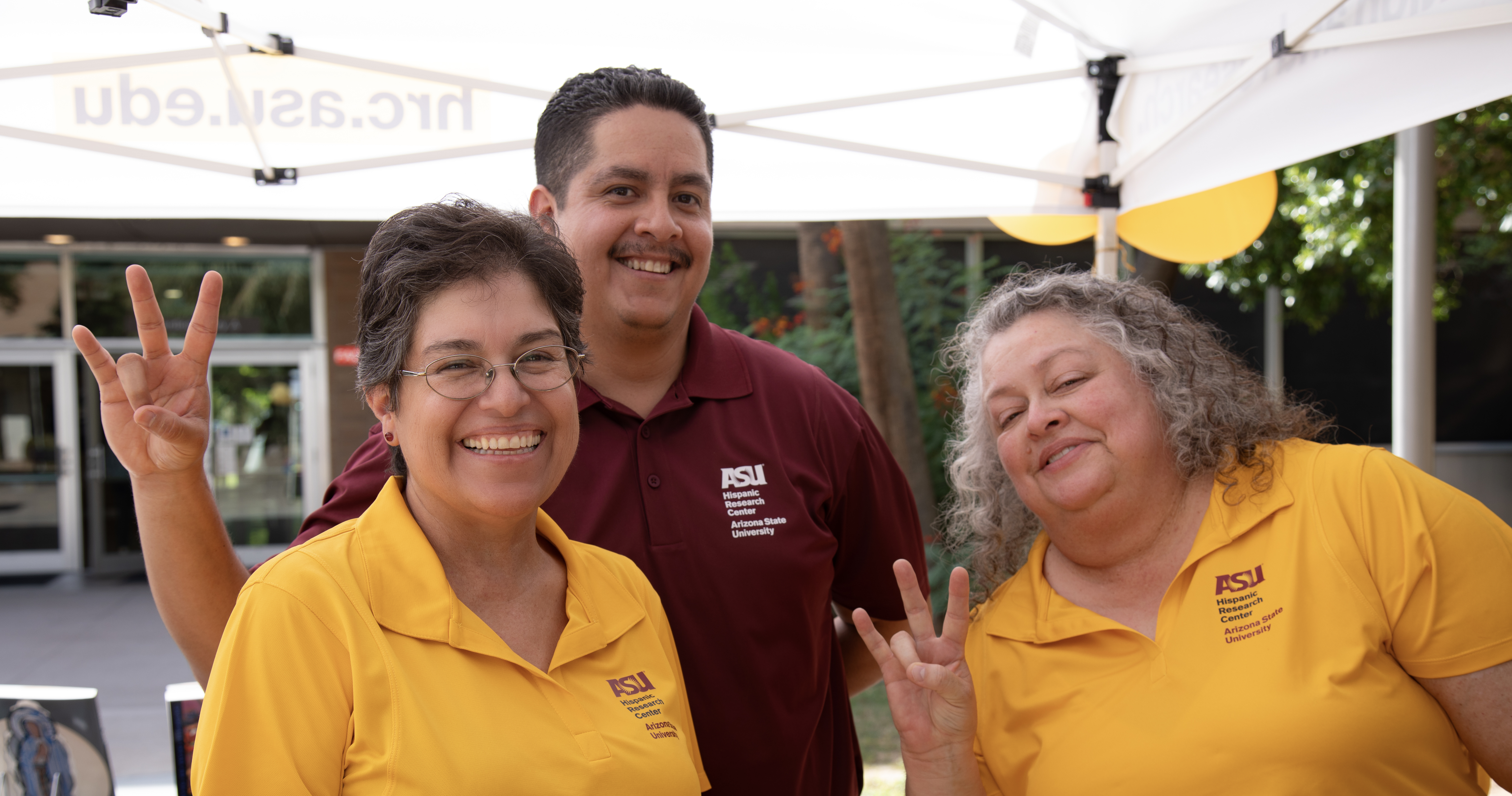 HRC people with hands making ASU fork symbol