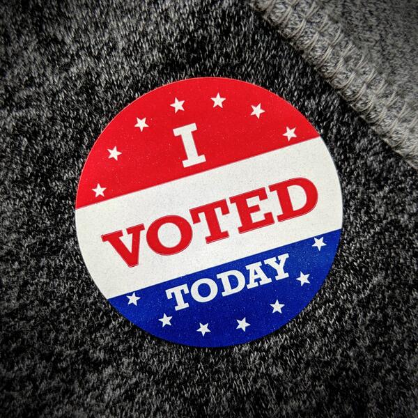 A circular sticker that reads "I voted today" with a red, white and blue color scheme.
